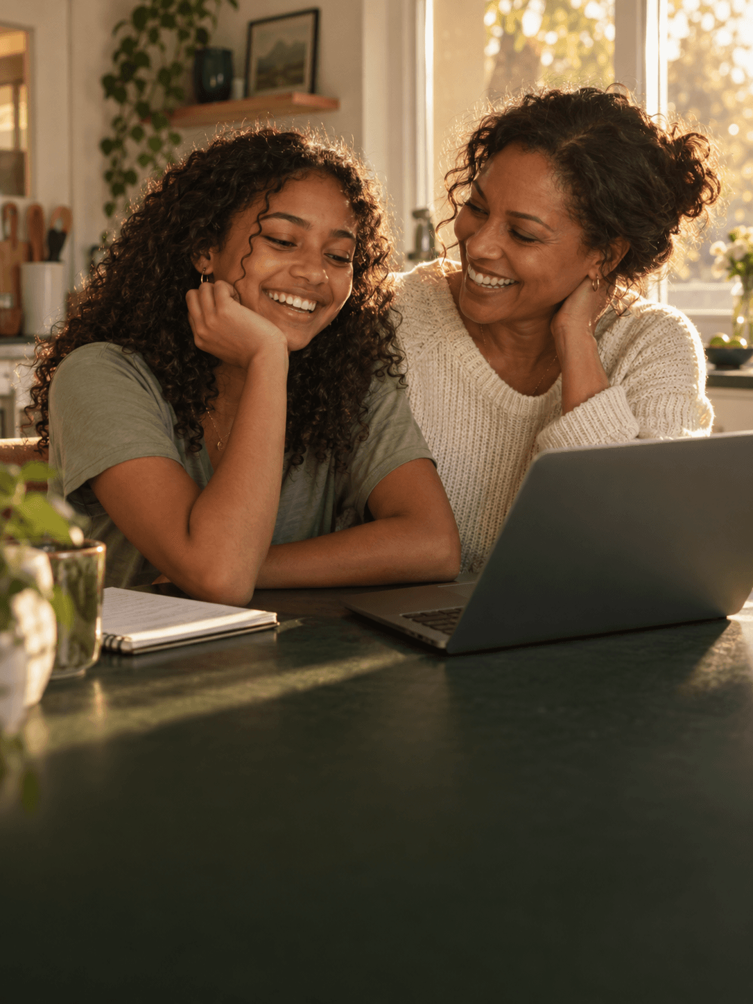 Illustration of a mother and teenage daughter sharing a happy moment over a laptop.